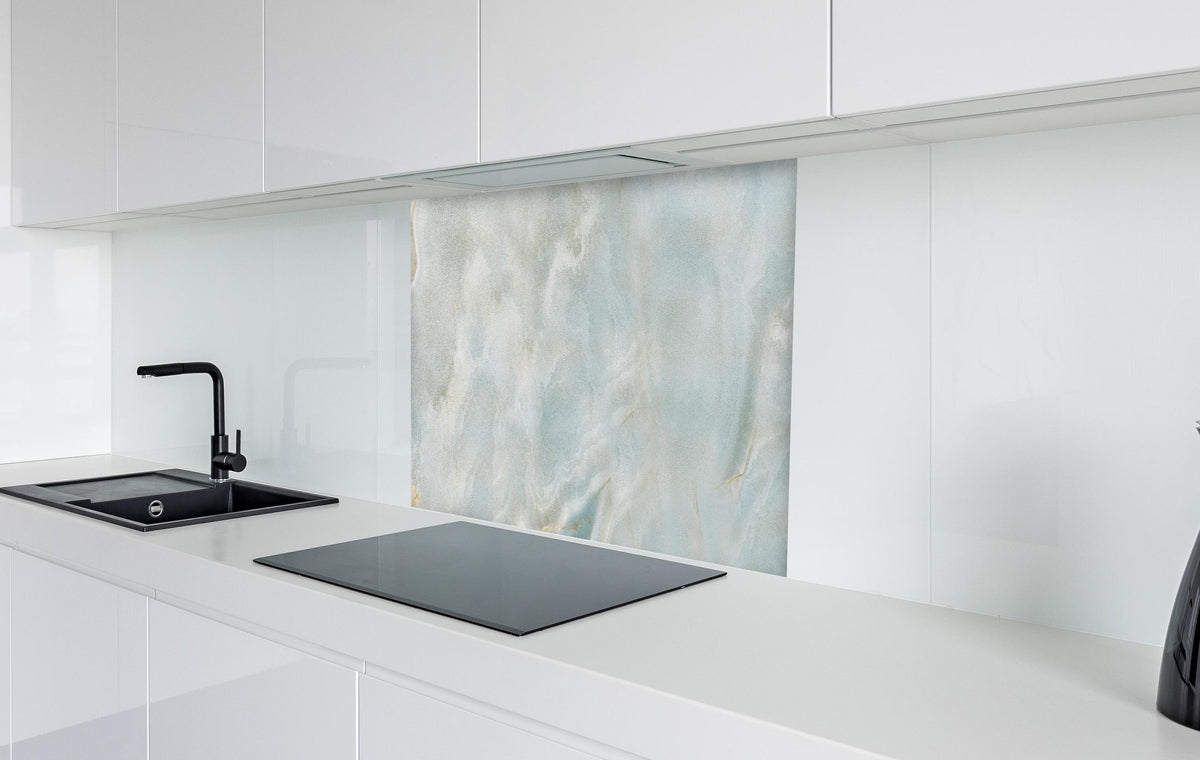 Spritzschutz - Polierter heller Onyx-Marmor in weißer Hochglanz-Küche hinter einem Cerankochfeld
